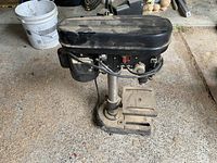 Full side view of the MasterCraft drill press showing base, column, worktable, and motor housing