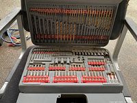 Top-down view of Ryobi drill bit set showing various bits and accessories arranged in the molded case.