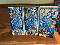Three unopened boxes of Aqua Globe Plant Waterers with packaging showing product image and branding.