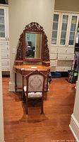Full view of dressing table with mirror and chair in room