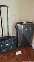Two rolling bags side by side on hardwood floor