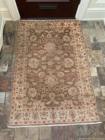 Full view of carpet on stone tile floor showing overall design.