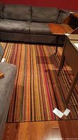 Overview of full rug in room setting with couch and tables