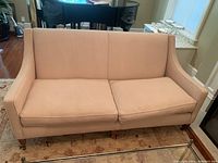 Front view of entire sofa showing upholstery, cushions, arms and legs