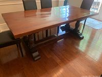 Full view of solid oak harvest table showing top surface and pedestal base