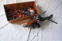 Photo showing the box full of assorted building blocks alongside the assembled Halo helicopter model.