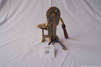 Front angled view of the wine bottle opener showing detailed grapevine design and clamp base.