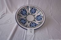Full view of the large round hand-painted ceramic serving bowl showing blue floral pattern on white.