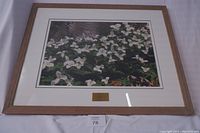Front view of framed photo depicting a field of trillium flowers with a wooden frame and white matte border.