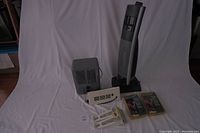 Lot of three portable heaters on a white backdrop: tall tower heater, small gray heater, and white panel heater