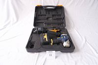 Rona 18V hammer drill kit inside molded plastic carrying case showing drill, charger and batteries.