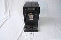 Front full view of the black Saeco HD8775 espresso machine on white backdrop showing overall condition