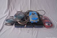 Sony Blu-ray player with multiple HDMI cables on top against a white backdrop