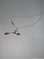 Full view of the 10kt gold chain necklace with two pendants displayed on white background.