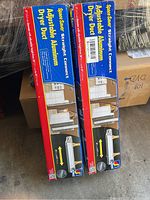 Two boxes of Space Saver Straight Connect Adjustable Aluminum Dryer Ducts, packaged in red and blue boxes showing adjustable length and installation instructions.