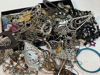 Mixed assortment of more than 30 earrings in various styles and materials