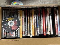 View inside the box showing DVDs lined up with visible titles and discs, indicating condition and packaging.