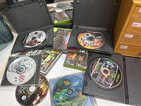 Lot of 9 video game discs and cases including PlayStation and Xbox titles such as A Bug's Life, NHL 97, Battlefield, Fight Night, Teenage Mutant Ninja Turtles, NFL Fever 2004, Star Wars, Grand Theft Auto.