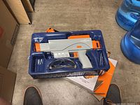 Splat R Ball Automatic toy gun in molded plastic tray with orange accents and included safety glasses