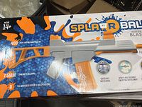 Box front showing orange and grey water bead blaster with brand and product details
