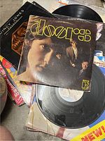 Close up of The Doors vinyl record on top with other records underneath including Quincy Jones