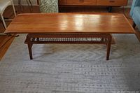 Top-down oblique view of surfboard-shaped teak table