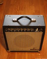 Front and top view of Jordan Reverb 25 guitar amplifier on wood floor showing control panel, handle and fabric grille with Jordan logo.
