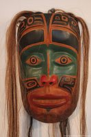 Front view of the mask showing full painted face and attached hair
