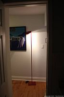 Lamp illuminated in a doorway, showing full height and ambient light effect