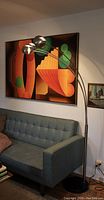 Lamp positioned beside sofa with large artwork behind