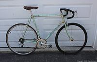 Left side profile of celeste Bianchi road bicycle showing frame, wheels, saddle and handlebars
