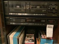 Front view of RCA VR-667HF VHS VCR showing dual cassette decks, buttons, and controls, with Technics CD player below.