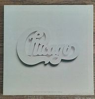 Front cover of one vinyl album with white background and embossed Chicago logo.