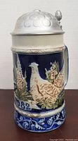 Front view of the ceramic Goebel stein with bird relief and the year 1982 displayed, showing condition and design details.