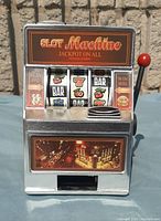 Front view showing slot machine design, reels, lever, and coin slot area.