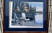Front view of framed 'Soulmates' print showing two white Adirondack chairs on a dock beside a tranquil lake with trees in autumn colors.