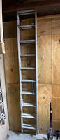 Full-length view of the aluminum extension ladder showing rungs and lock
