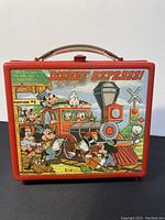Front view of the red Disney Express lunchbox showing colorful Disney characters on a train