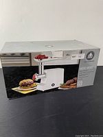 Photo of product box showing image of grinder and food