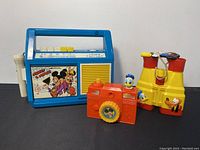 Front view of Mickey Minnie Mouse cassette player along with Donald Duck camera and Disney binoculars