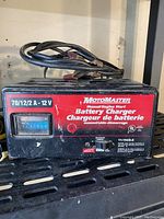 Front view of Motomaster battery charger showing model and power ratings.