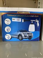 Product box showing Tornado Brush Cleaning Gun packaging with images of parts and a car.