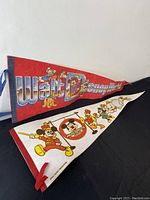 Both pennants laid flat showing full design and colors, Mickey Mouse Club and Walt Disney World themes