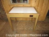Full view front angle of wooden artist light table with white illuminated surface and control switch on front side.