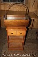 Night stand showing full height view with two drawers and open shelf, and wooden basket placed on top.