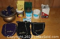 Full view of entire lot showing brass spittoon, multiple Crown Royal bags, various tobacco tins and pipe cleaner boxes