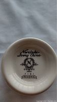 Close-up photo of the bottom marking on a china piece: Noritake Ivory China with series and pattern information showing 'Japan 7191 Reverie'.