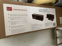 Box packaging of Homenations convertible wall mount desk with product details and images of the desk showing open and closed configurations.