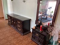 Smaller matching dark wood vanity with three drawers and large mirror