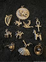 Photo showing all 11 sterling silver charms on black fabric background